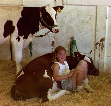 Little Girl sitting back on her 4h type moo calf